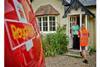 Royal_Mail_postwoman_delivering_to_house_fixed-600-width