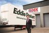 Transdek CEO and Founder Mark Adams in front of a Queens Award winning Wedge trailer