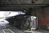 truck on side under bridge