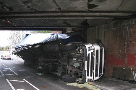 truck on side under bridge