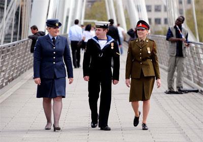 From left, a Royal Air Force servicewoman, a Royal Navy sailor and an Army soldier stroll through London prior to Armed Forces Day 1010.  This image is fully model released.