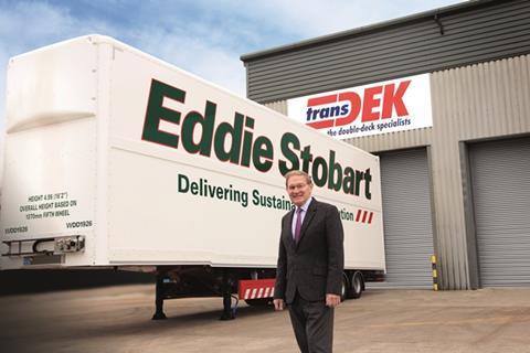 Transdek CEO and Founder Mark Adams in front of a Queens Award winning Wedge trailer