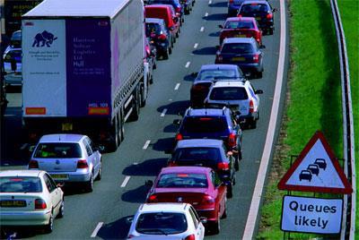 warning sign of queues ahead at traffic jam at roadworks on the A1/M1 motorway near Leeds Yorkshire UK