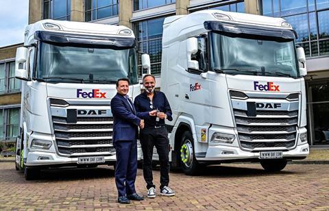 (R-L) Michael Rudolph, FedEx senior manager planning and engineering, receives the keys of the first vehicles from David Kiss, European sales director of DAF Trucks.