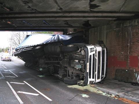truck on side under bridge